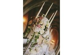 Candleholders with white and pale pink roses for wedding banquet