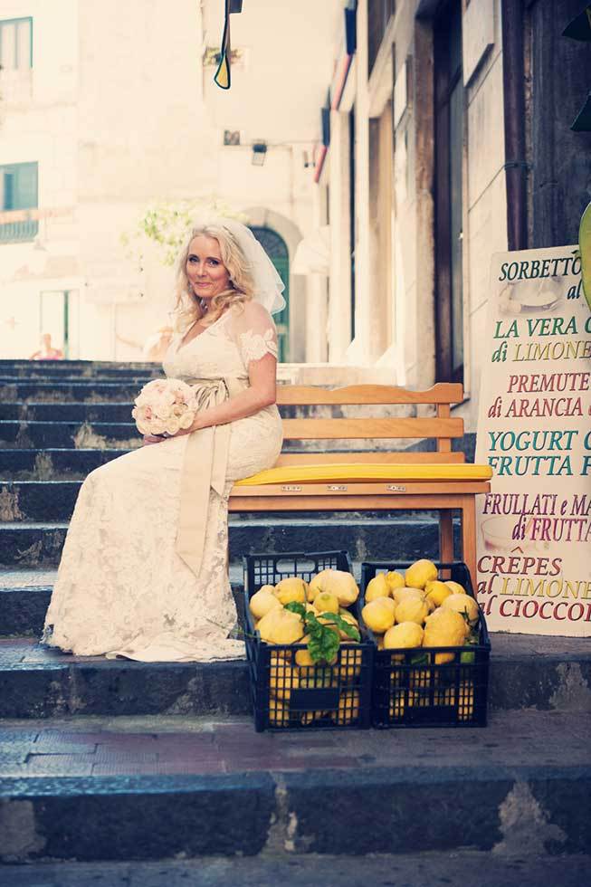 Portrait of a bride in front of a fruit stand in Atrani
