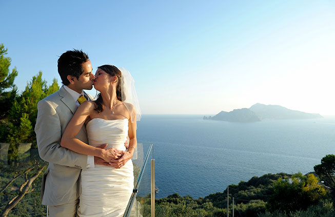 Newlyweds kissing on a terrace with seaview in Sorrento