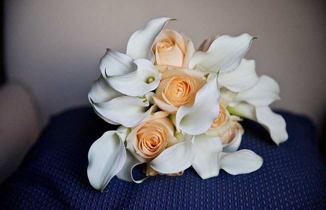 Bridal bouquet with orange roses white calla lilies