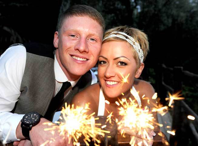 Bridal couple with sparklers at a wedding reception in Sorrento