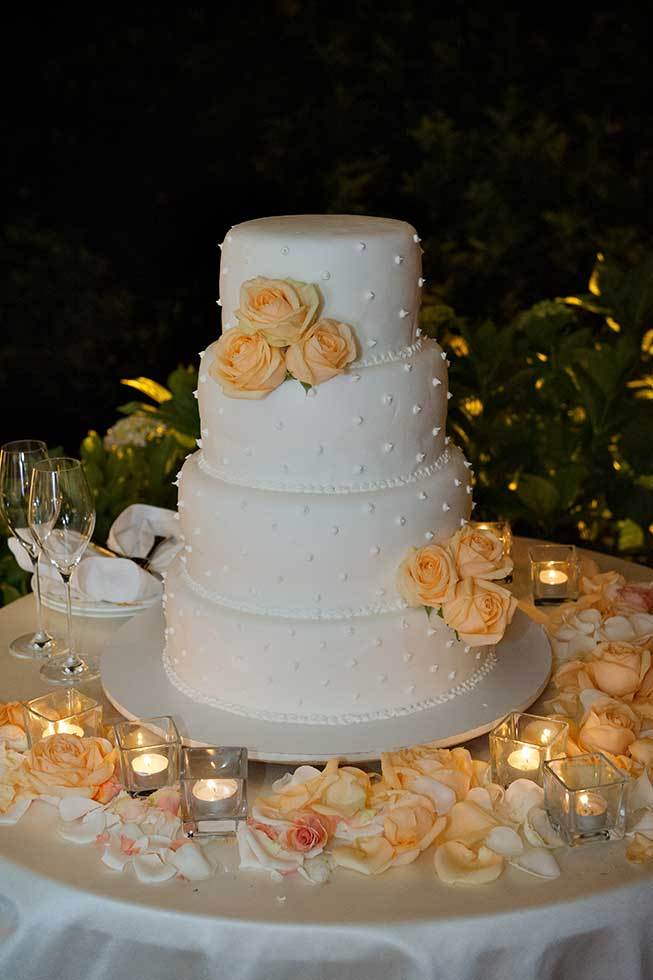 Wedding cake decorated with orange roses